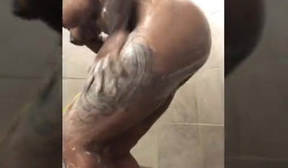 Horny mature ebony with short blonde hair masturbates vigorously while in a shower