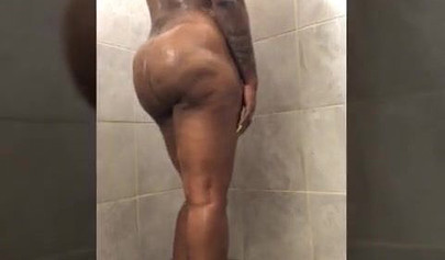 Horny mature ebony with short blonde hair masturbates vigorously while in a shower