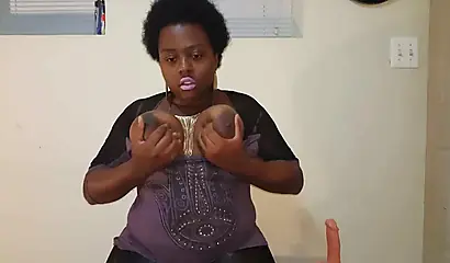 Chubby black mommy with big tits and round ass fucks her wet pussy with a dildo