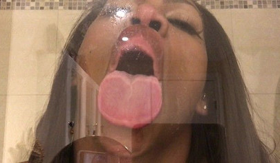 Black amateur stripper kisses the glass and is horny while under the shower