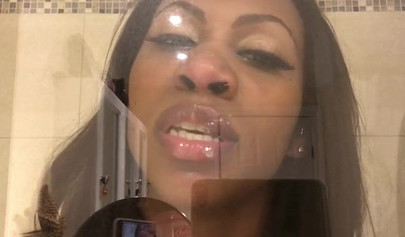 Black amateur stripper kisses the glass and is horny while under the shower