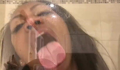 Black amateur stripper kisses the glass and is horny while under the shower