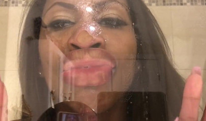 Black amateur stripper kisses the glass and is horny while under the shower