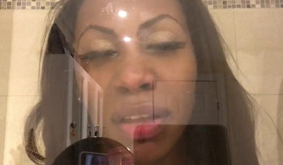 Black amateur stripper kisses the glass and is horny while under the shower