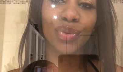 Black amateur stripper kisses the glass and is horny while under the shower