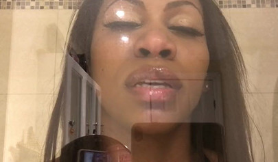 Black amateur stripper kisses the glass and is horny while under the shower