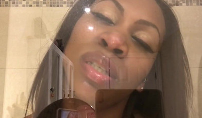 Black amateur stripper kisses the glass and is horny while under the shower