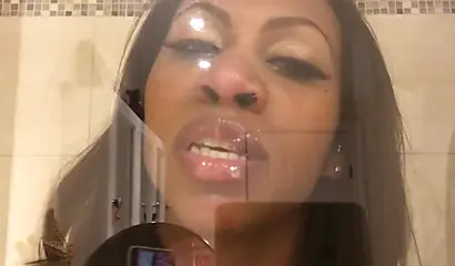 Black amateur stripper kisses the glass and is horny while under the shower