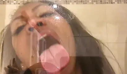 Black amateur stripper kisses the glass and is horny while under the shower