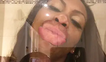 Black amateur stripper kisses the glass and is horny while under the shower