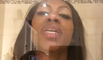 Black amateur stripper kisses the glass and is horny while under the shower