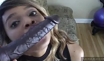 Stunning black babe loses her dress and takes a big black dildo up her pussy