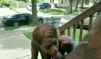 Horny black babe gives a long and sloppy blowjob on a front porch during daylight