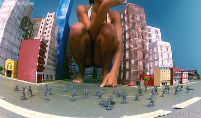 Super hot and sexy ebony giantess walks around a small city showing her attributes