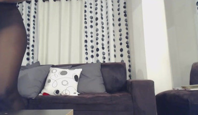 Ebony with glasses sucks a white dildo and then has it deep in her wet pussy