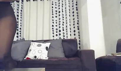 Ebony with glasses sucks a white dildo and then has it deep in her wet pussy