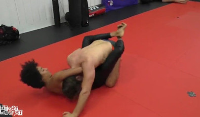 Athletic ebony babe wrestles topless with a white guy and subdues him erotically