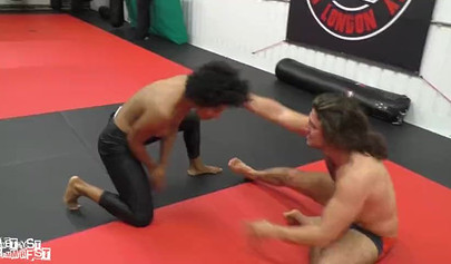 Athletic ebony babe wrestles topless with a white guy and subdues him erotically