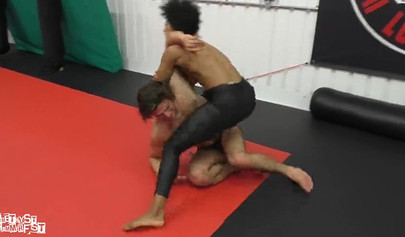 Athletic ebony babe wrestles topless with a white guy and subdues him erotically