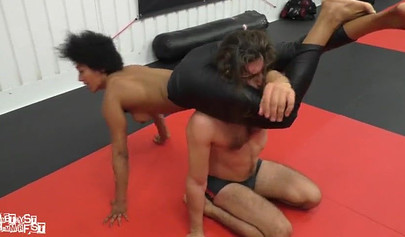 Athletic ebony babe wrestles topless with a white guy and subdues him erotically