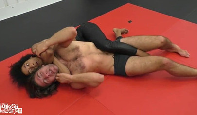 Athletic ebony babe wrestles topless with a white guy and subdues him erotically