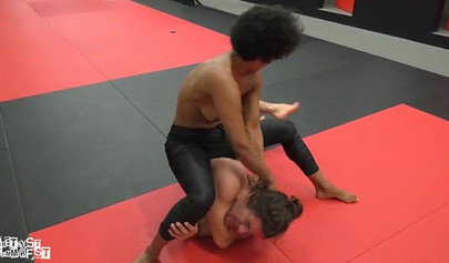 Athletic ebony babe wrestles topless with a white guy and subdues him erotically