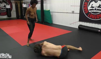 Athletic ebony babe wrestles topless with a white guy and subdues him erotically