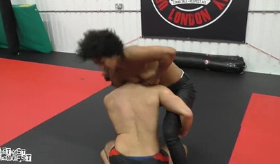 Athletic ebony babe wrestles topless with a white guy and subdues him erotically