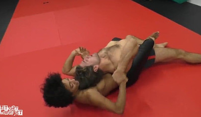 Athletic ebony babe wrestles topless with a white guy and subdues him erotically