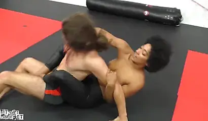 Athletic ebony babe wrestles topless with a white guy and subdues him erotically