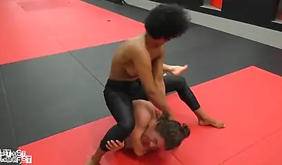 Athletic ebony babe wrestles topless with a white guy and subdues him erotically