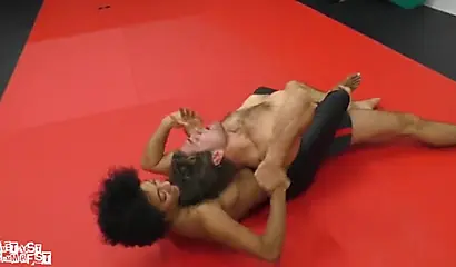 Athletic ebony babe wrestles topless with a white guy and subdues him erotically