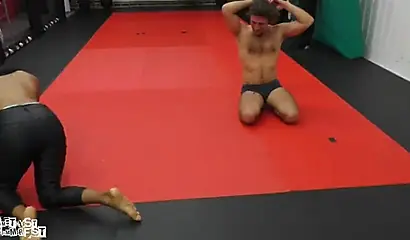 Athletic ebony babe wrestles topless with a white guy and subdues him erotically