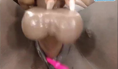 Black chick with a massive ass enjoys toys in her pussy while rubbing her clit