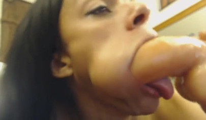 Ebony cam models sucks on fake white dick and gets her face covered in some cum