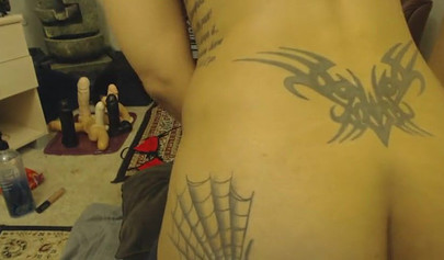 Beautiful ebony chick with a thick ass and tattoos plows herself with a dildo