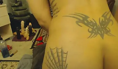 Beautiful ebony chick with a thick ass and tattoos plows herself with a dildo