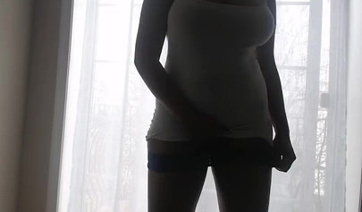 Ebony girl in white clothes slowly strips in front of the curtain and loves it