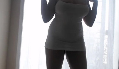 Ebony girl in white clothes slowly strips in front of the curtain and loves it