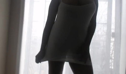 Ebony girl in white clothes slowly strips in front of the curtain and loves it