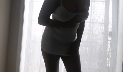 Ebony girl in white clothes slowly strips in front of the curtain and loves it