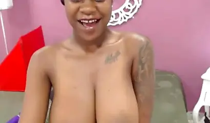 Ebony slut with gigantic tits uses a vibrator to stimulate her pussy and cums