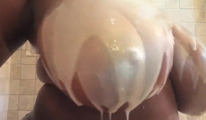 Kinky black MILF washes her gigantic tits and gives you jerk off instructions