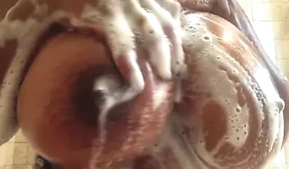 Kinky black MILF washes her gigantic tits and gives you jerk off instructions