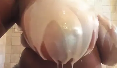 Kinky black MILF washes her gigantic tits and gives you jerk off instructions