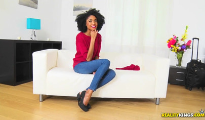 Curly-haired ebony serves a nice guy on a white couch