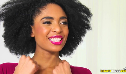 Curly-haired ebony serves a nice guy on a white couch