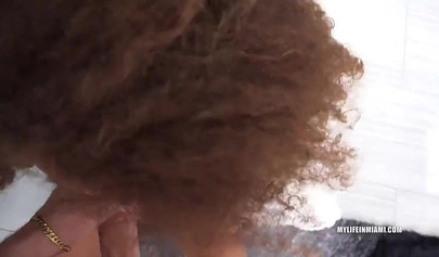 Curly-haired black cutie Cecilia Lion is riding a giant cock