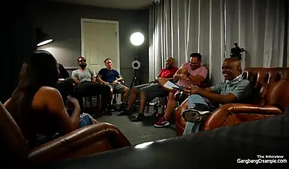 Busty black whore is satisfying a lot of guys during a gangbang