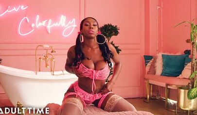 Ebony Mystique is posing in pink lingerie and masturbating